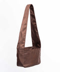 Brown Shield Crossbody Mini med long strop til at bæres crossbody.