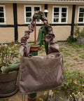 Grey Shield Midi Shopper. Rufflestrop og snørelukning for at holde tasken kompakt.